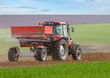 Foto: an agricultural tractor starts a chemical treatment an agricultural tractor starts a chemical treatment