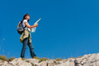 hiker with the map  in the mountains
