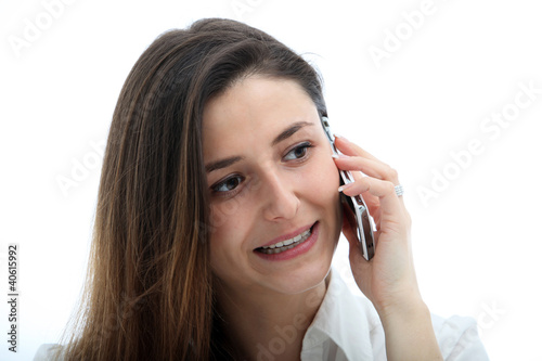 Photo: Businesswoman talking on cell phone isolated on white Businesswoman talking on cell phone isolated on white