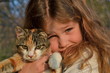 Green eyed little girl with her tortoiseshell cat Green eyed little girl with her tortoiseshell cat