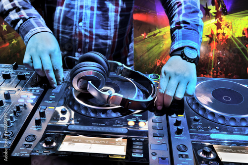 Photo: Dj mixes the track in nightclub at party Dj mixes the track in nightclub at party