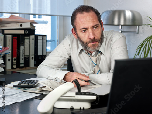 Photo: Businessman at workdesk Businessman at workdesk