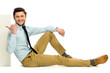 Man sitting and pointing at blank poster