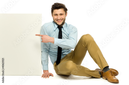 Photo: Man pointing at blank poster Man pointing at blank poster