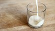 Pouring home made oat milk in a glass.