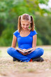 Teenage girl sitting and reading a book