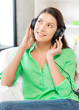 happy teenage girl in big headphones