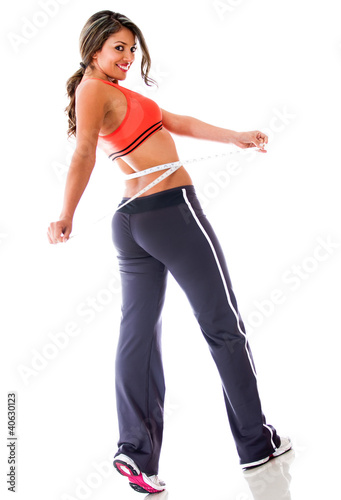 Photo: Woman measuring her waist Woman measuring her waist