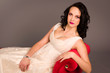 Portrait of a beautiful happy bride on red sofa Portrait of a beautiful happy bride on red sofa