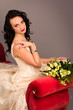 Portrait of a beautiful happy bride on red sofa Portrait of a beautiful happy bride on red sofa