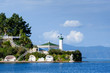 Lighthouse and recreational buildings on cape, harbour entrance