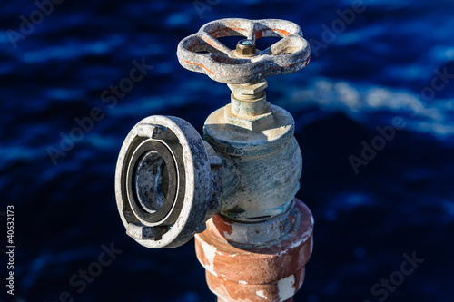 Photo: Old rusty water valve at pier Old rusty water valve at pier