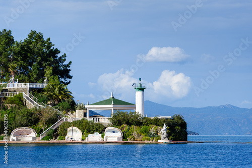 Photo: Lighthouse and recreational buildings on cape, harbour entrance Lighthouse and recreational buildings on cape, harbour entrance