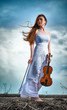 The red-haired girl with a violin outdoor
