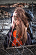 The red-haired girl with a violin sitting on the ashes