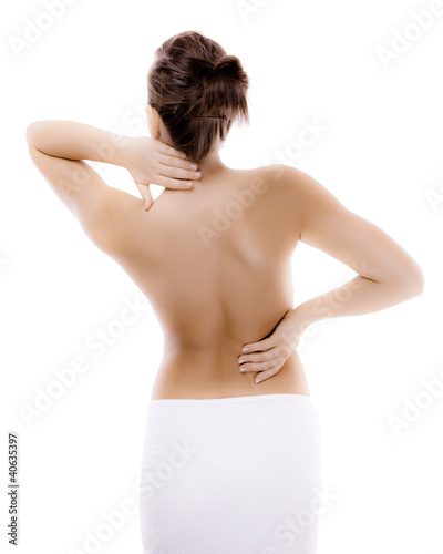 Photo: Woman massaging pain back isolated on white background Woman massaging pain back isolated on white background