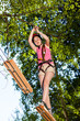 Girl climbing in adventure park