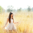 Asian indian woman walking in golden dried field