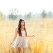 Asian indian woman walking in golden dried field Asian indian woman walking in golden dried field