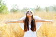 Details der Fotografie Angel girl in golden field with feather white wings