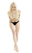 Foto: The young woman in a bathing suit cautiously goes The young woman in a bathing suit cautiously goes