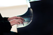Hands on piano keyboard