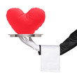 Photo: Hand holding a tray with red heart shaped pillow on it Hand holding a tray with red heart shaped pillow on it