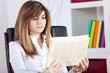 Businesswoman reading the newspaper Businesswoman reading the newspaper