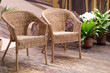 Two straw armchairs in a hall with flowers Two straw armchairs in a hall with flowers