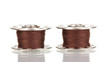 Metal spools of thread isolated on white