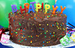 Photo: Chocolate cake with Happy Birthday candles. Selective focus on Chocolate cake with Happy Birthday candles. Selective focus on