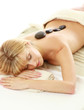 pretty woman receiving a therapy with hot stones in spa center pretty woman receiving a therapy with hot stones in spa center