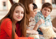 Smiling teenage girl spending time with her friends