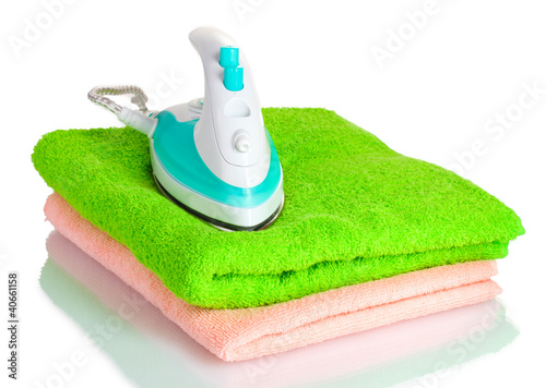 Foto: Two towels and iron isolated on white Two towels and iron isolated on white