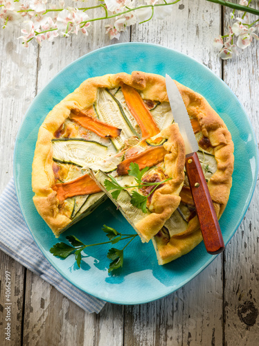 Photo: vegetables cake over dish on wood background vegetables cake over dish on wood background