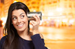 Detalii fotografie Young woman hearing using a metal tin can at night city