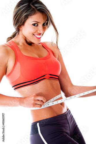 Photo: Woman measuring her waist Woman measuring her waist