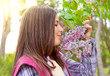 Cute teenage girl smelling flowers in spring park Cute teenage girl smelling flowers in spring park