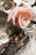 Bunch of flowers and gold rings on old wood