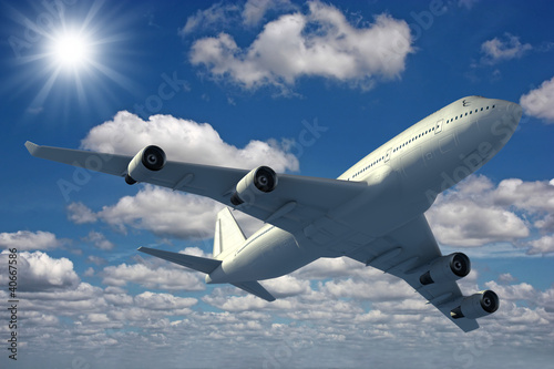 Photo: Airplane flying over a blue sky Airplane flying over a blue sky