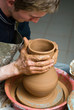 hands of a potter, creating an earthen jar on the circle hands of a potter, creating an earthen jar on the circle