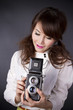 female model pose with classic camera on her head. female model pose with classic camera on her head.