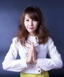 Sawasdee, Female model join own palms to make praying gesture.