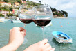 Two wineglasses in the hands against Portvenere, Italy