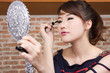 put on make up, female model using black mascara with eyelash. put on make up, female model using black mascara with eyelash.