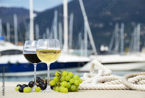 Photo: Pair of wineglasses against yacht pier Pair of wineglasses against yacht pier
