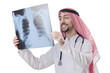 Arab doctor examining x-ray print