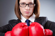 Young businesswoman in boxing concept