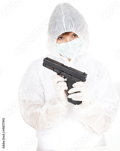 Photo: young woman in protective uniform and mask with gun young woman in protective uniform and mask with gun