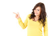cheerful young woman pointing up, white background